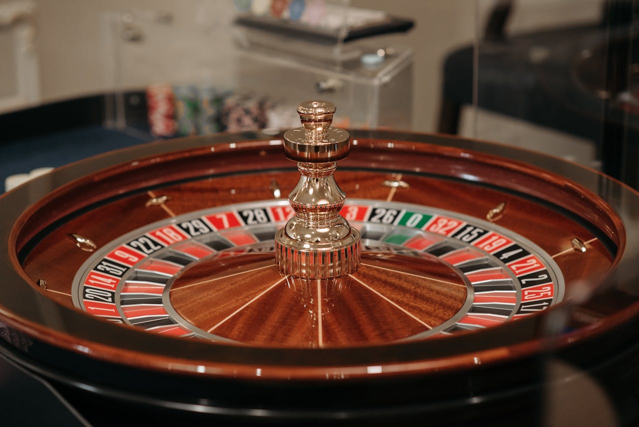 services-05 Close-up of a classic roulette wheel in a casino setting showcasing the elegant wooden design.