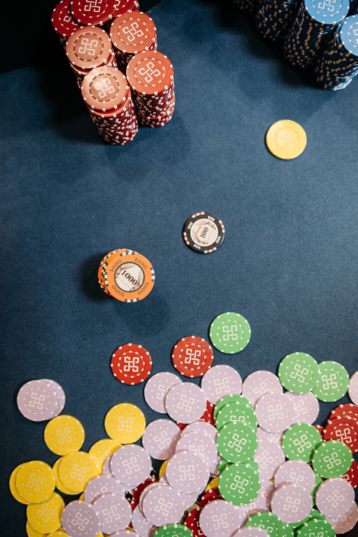 get-in-touch Colorful casino chips scattered and stacked on a gaming table, capturing the essence of gambling excitement.