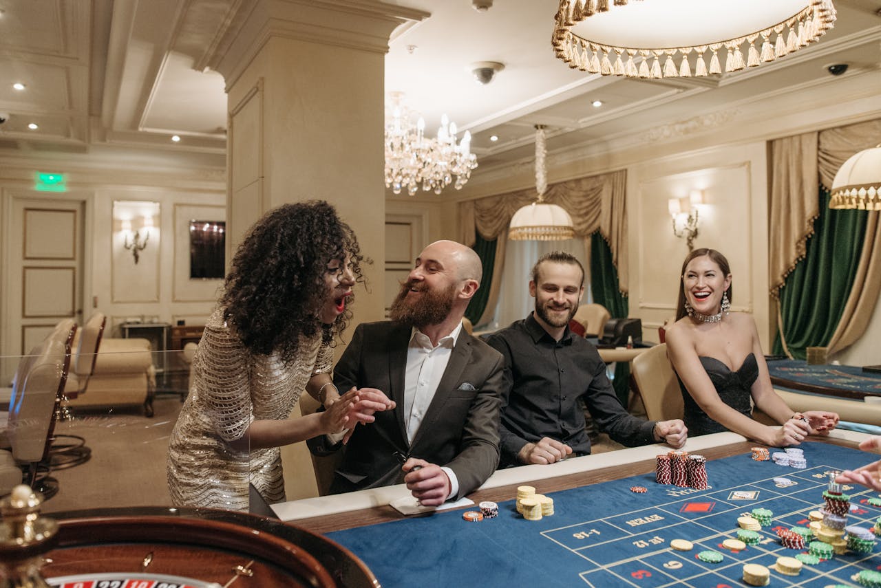 Group of adults enjoying a lively night at a casino poker table, gambling with friends.